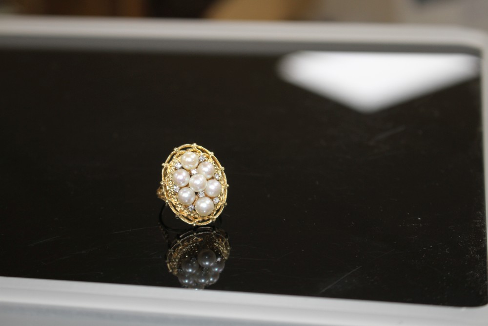 A modern 14k yellow metal, cultured pear and diamond cluster set oval dress ring, size P, gross weight 9.2 grams.